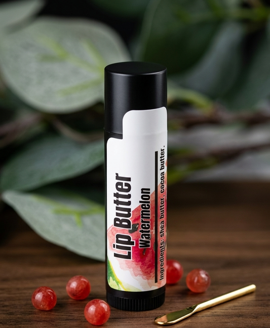 Lip Butter with watermelon flavor on a wooden surface with watermelon seeds and a spoon.