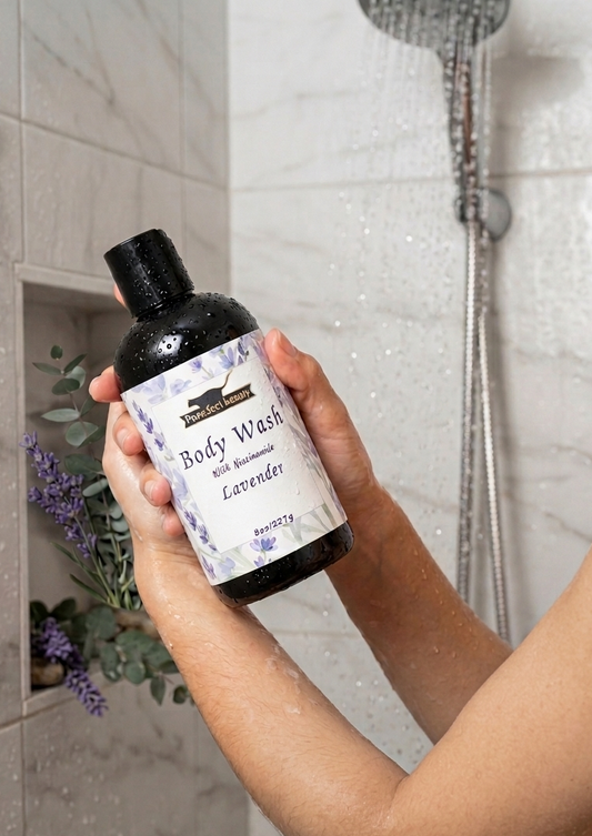 Hand holding a bottle of lavender body wash by Purr.fect beauty in a bathroom setting