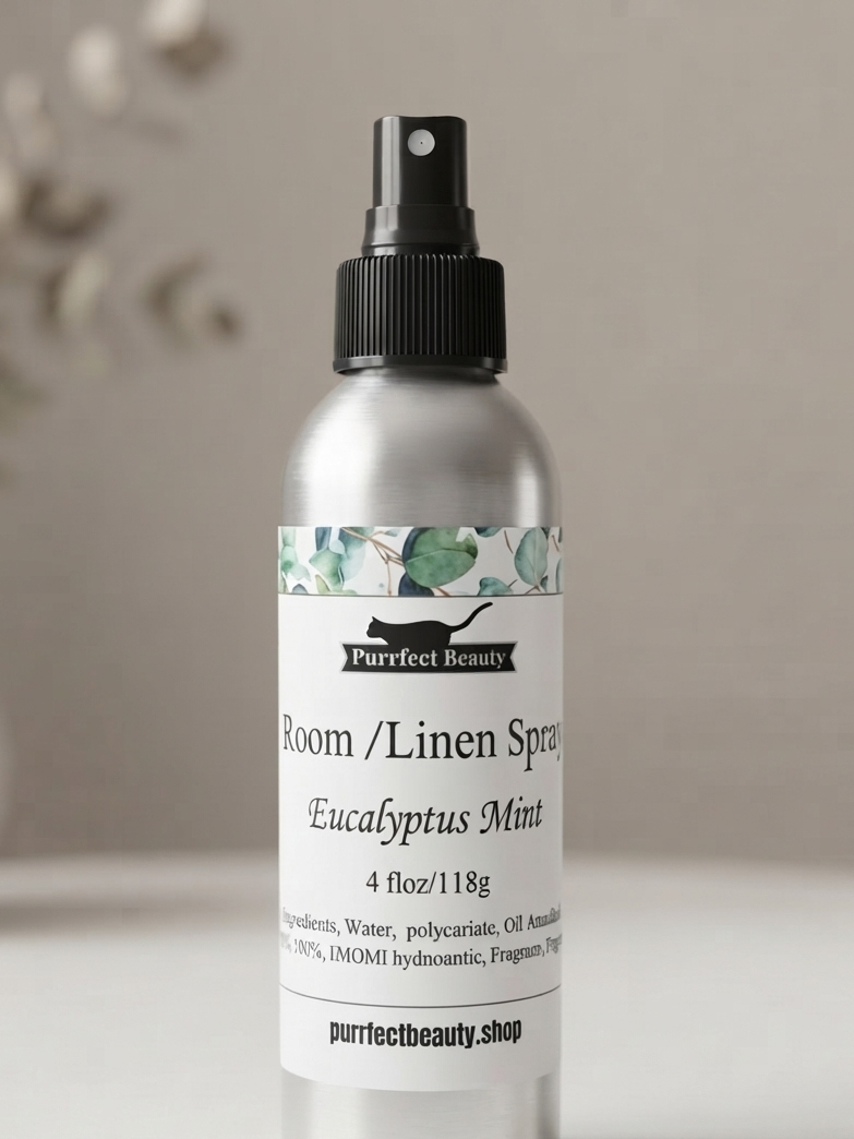 A silver aluminum room and linen spray bottle with a black spray top, featuring a white label with green floral accents and text reading 'Purfect Beauty' and 'Room / Linen Spray Eucalyptus Mint'.
