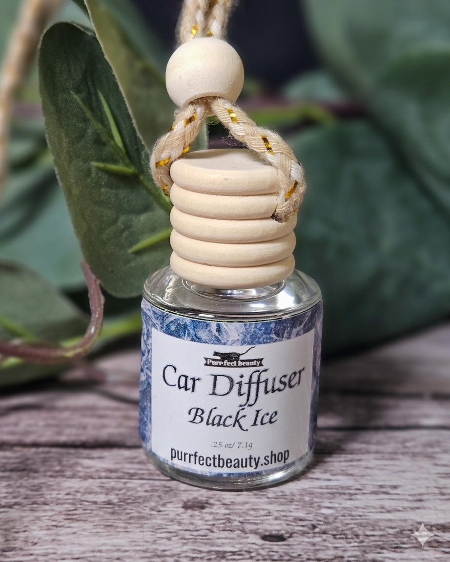 Black Ice Car diffuser with wooden holder on a wooden surface with green leaves in the background