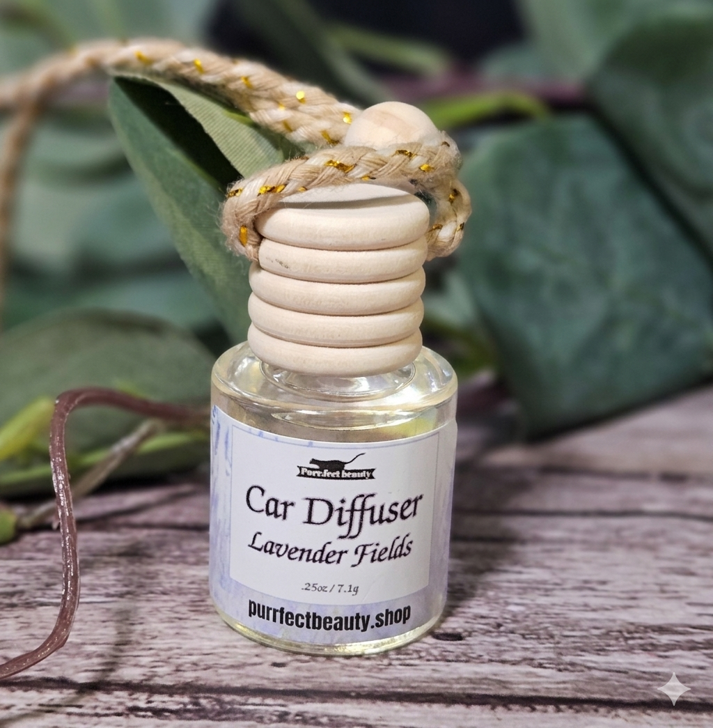 Lavender Car diffuser with wooden design on a wooden surface with green leaves in the background